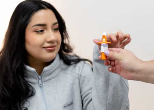 patient holding spravato bottle