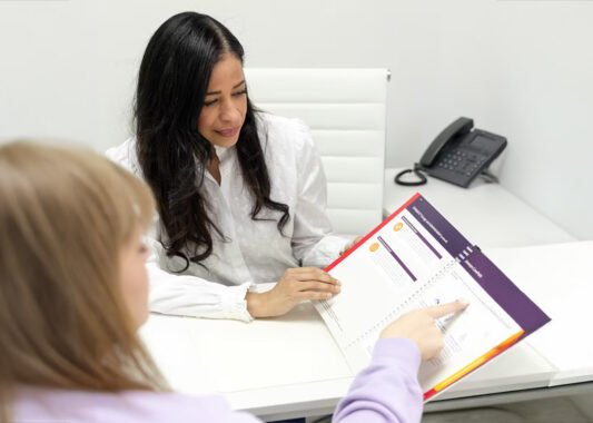 Dr. Sanchez at desk with medication information