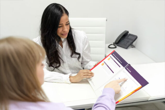 Dr. Sanchez at desk with medication information